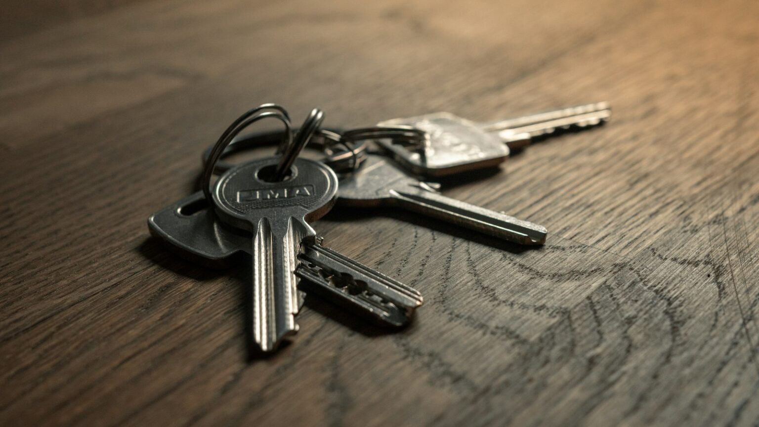 Secure Your Home with Guardian Angel Lock & Security Set of house keys on a wooden table